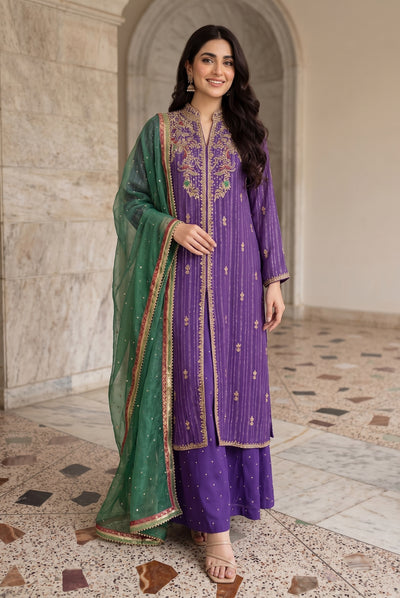 Three piece Pakistani ensemble pairs deep royal purple with vivid emerald green accents.